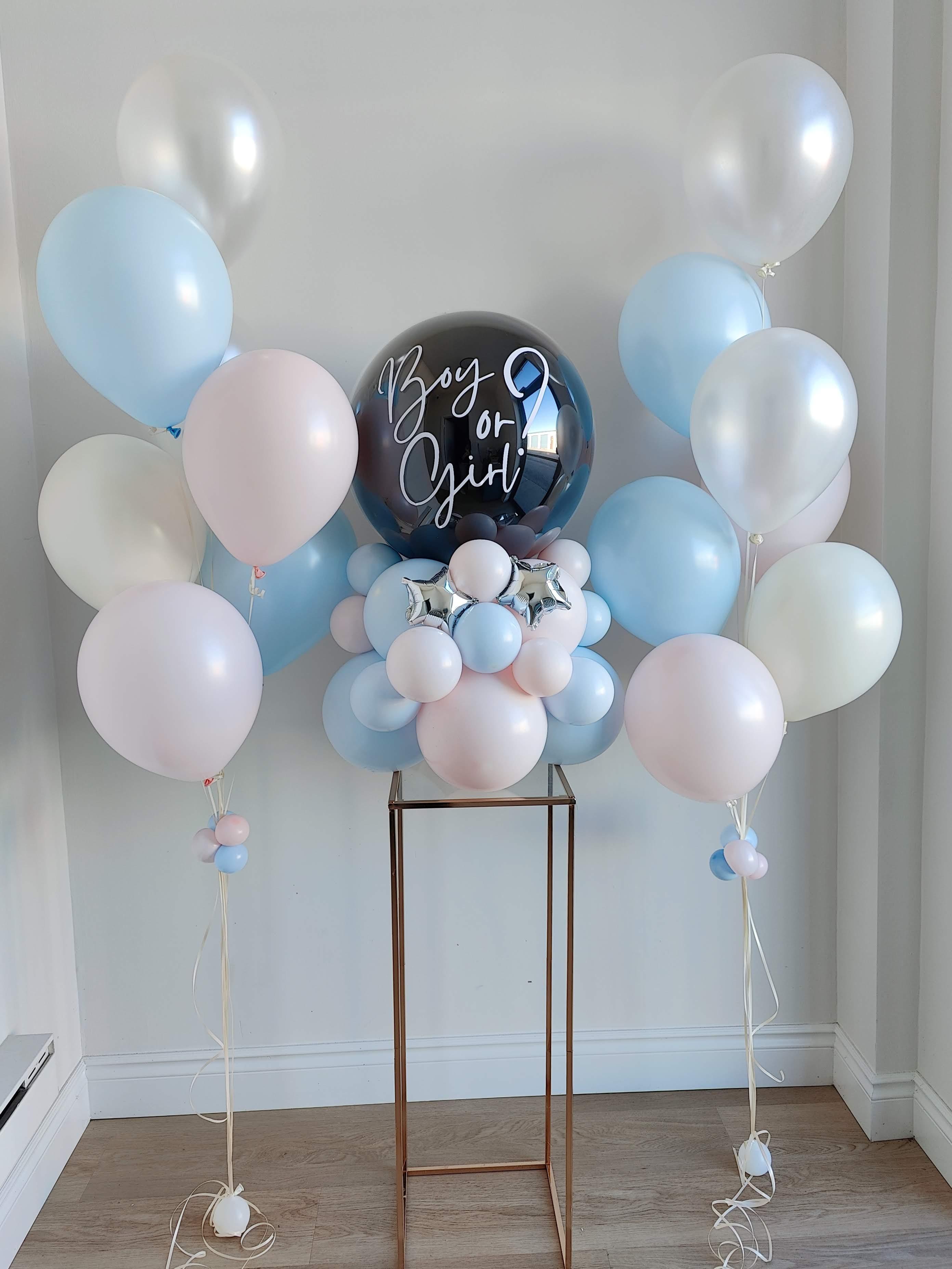 Gender reveal balloon arrangement with pastel pink and blue balloons, Boy or Girl sign