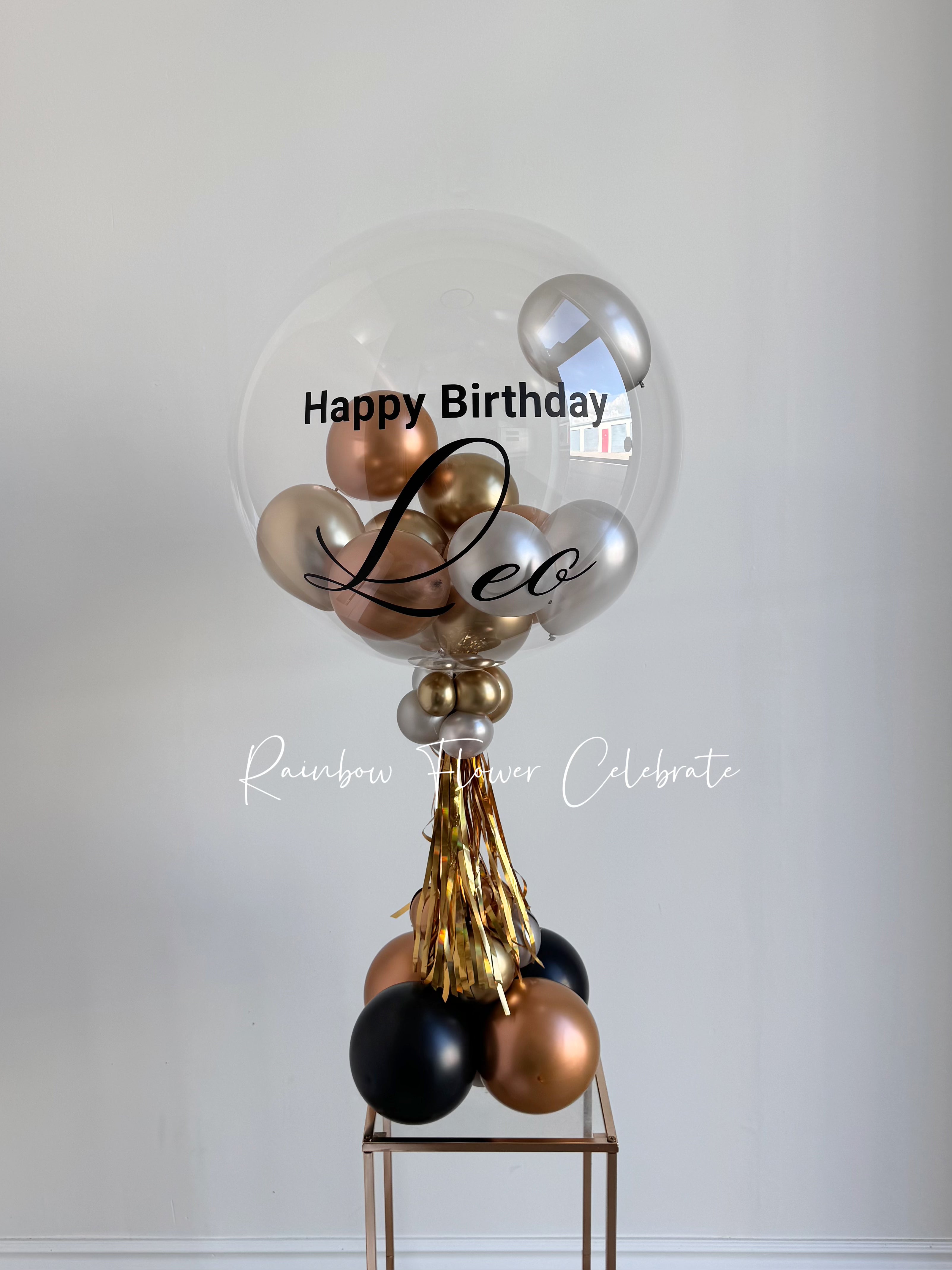 Black, gold, silver, copper mini balloons in a clear bobo balloon with Happy Birthday Leo on balloon, great for 16th boy birthday centrepieces decoration