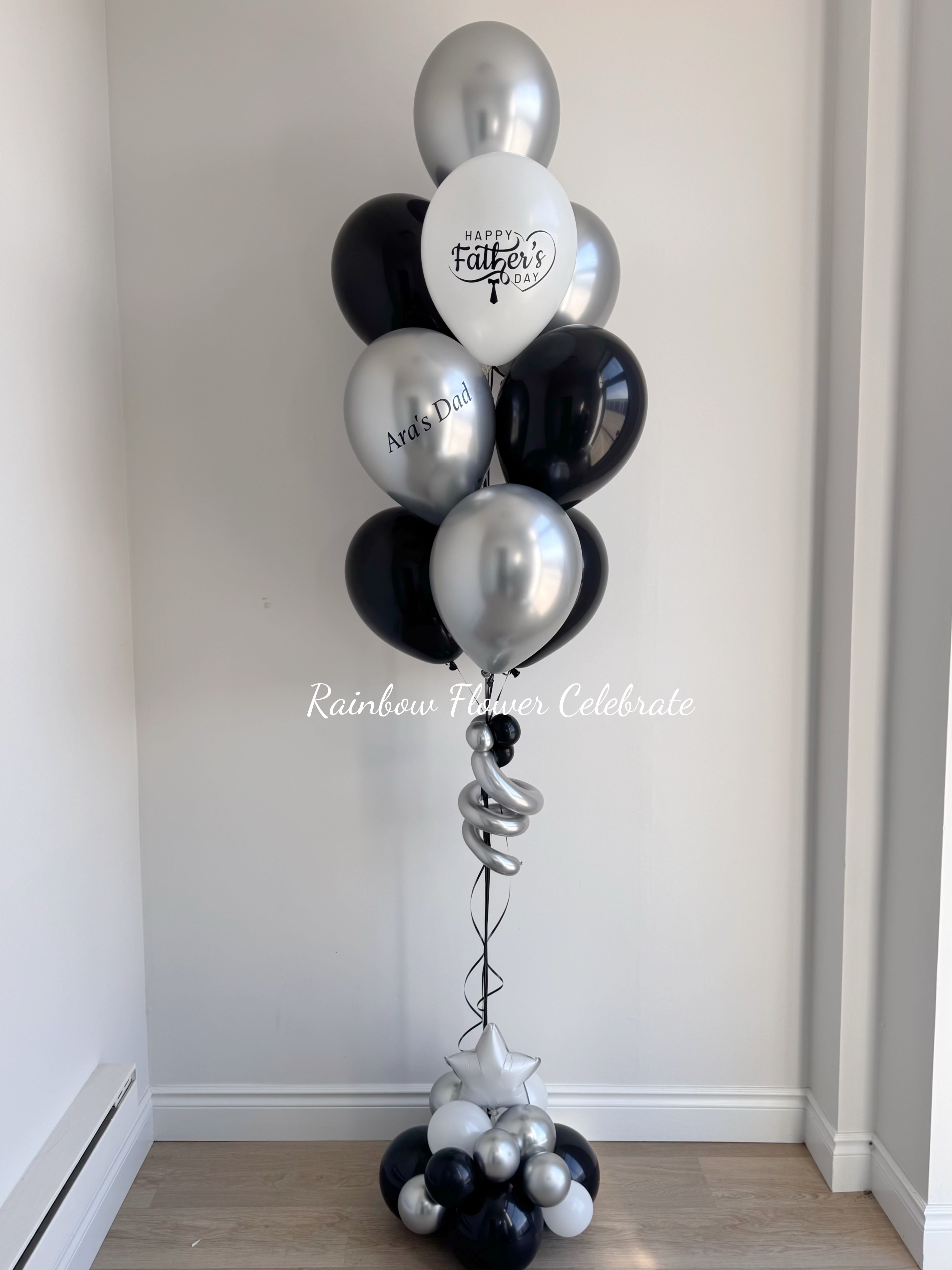 Balloon bouquet with black, silver, and white balloons with personalized vinyl happy father's day on white balloon